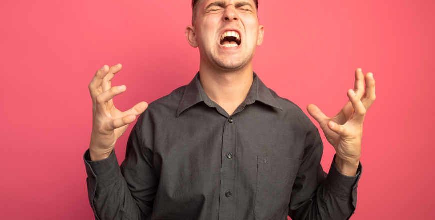 young-handsome-man-grey-shirt-shouting-with-raised-arms-angry-crazy-mad-standing-pink-wall (1)